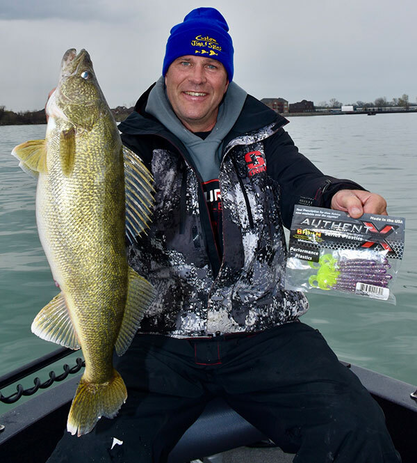 Andrew is holding up the big walleye he just caught