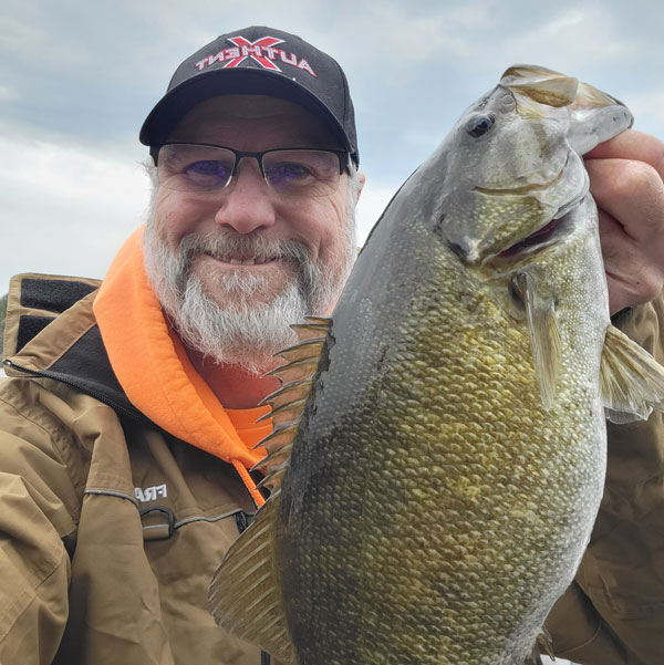 Walt with a bigmouth bass that he caught under the pier.