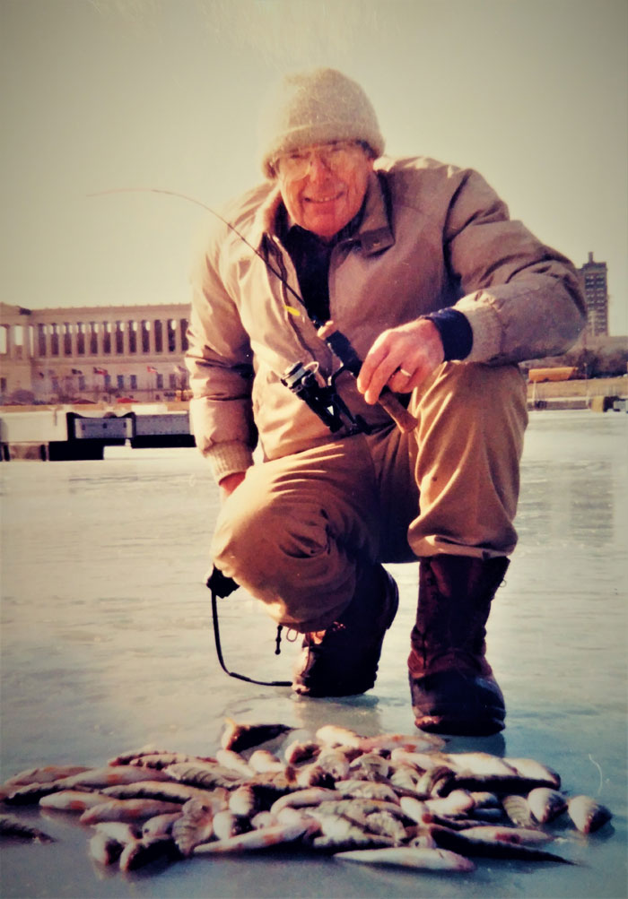 Chuck standing over his ice fishing hole