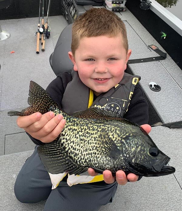 Kid holding big fat crappie