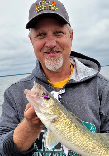 Deadstick Doug holding up a walleye