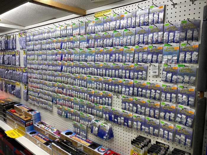 Wall full of packages of Custom Jigs and Spins lures and jigs