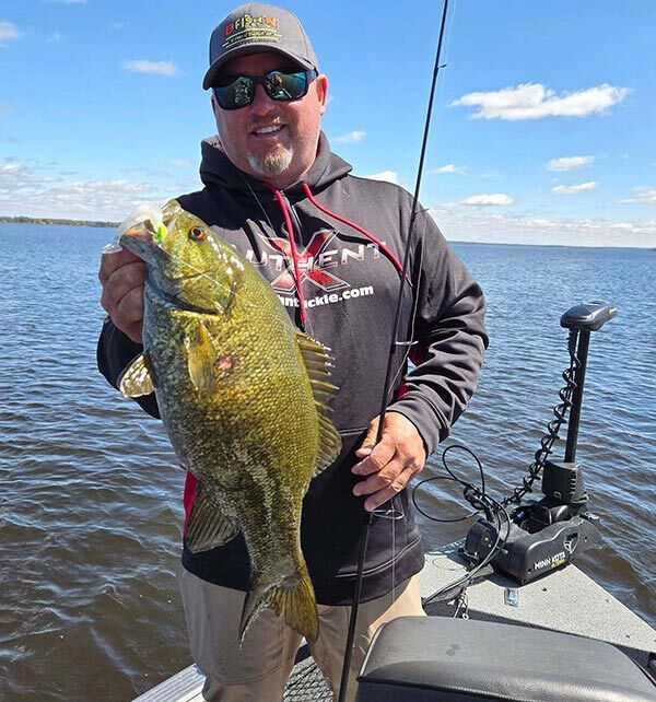 Guide Justin Kohn with a monster smallmouth on a 2.45” Pulse-R and Draggin’ Jig 