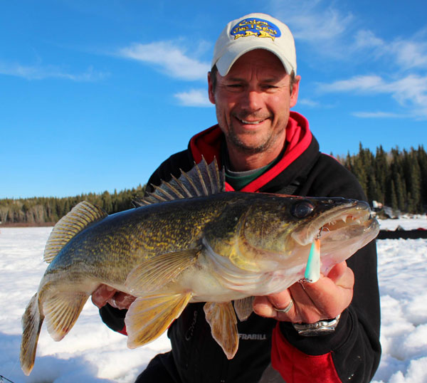 Mike shown with a walleye with a Slender Spoon in his mouth