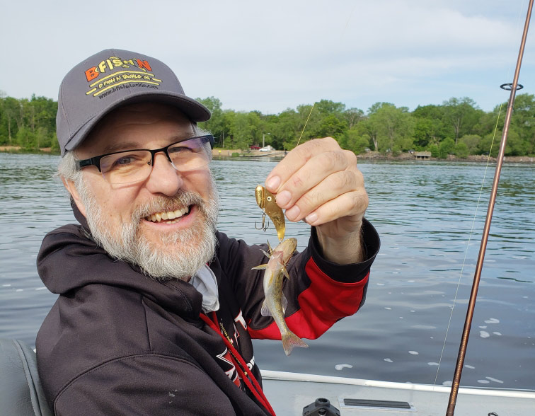 Walt is holding a most embarrassing teenie weenie fish