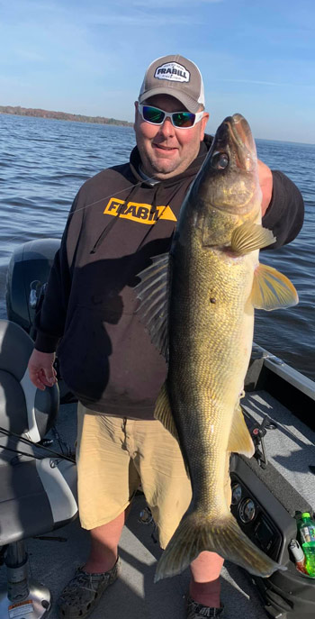 Wisconsin guide Jesse Quale holding up a far more impressively large fish than Walt above.