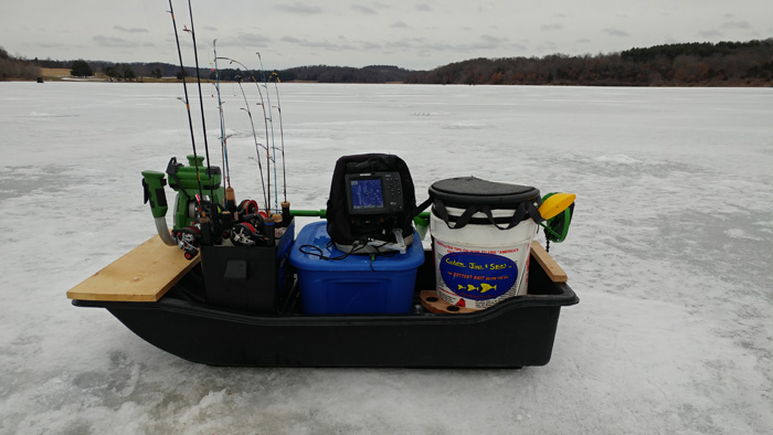 Ice fishing sled full of fishing gear